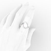 Pear twist breastmilk ring in 18K white gold, worn on a hand
